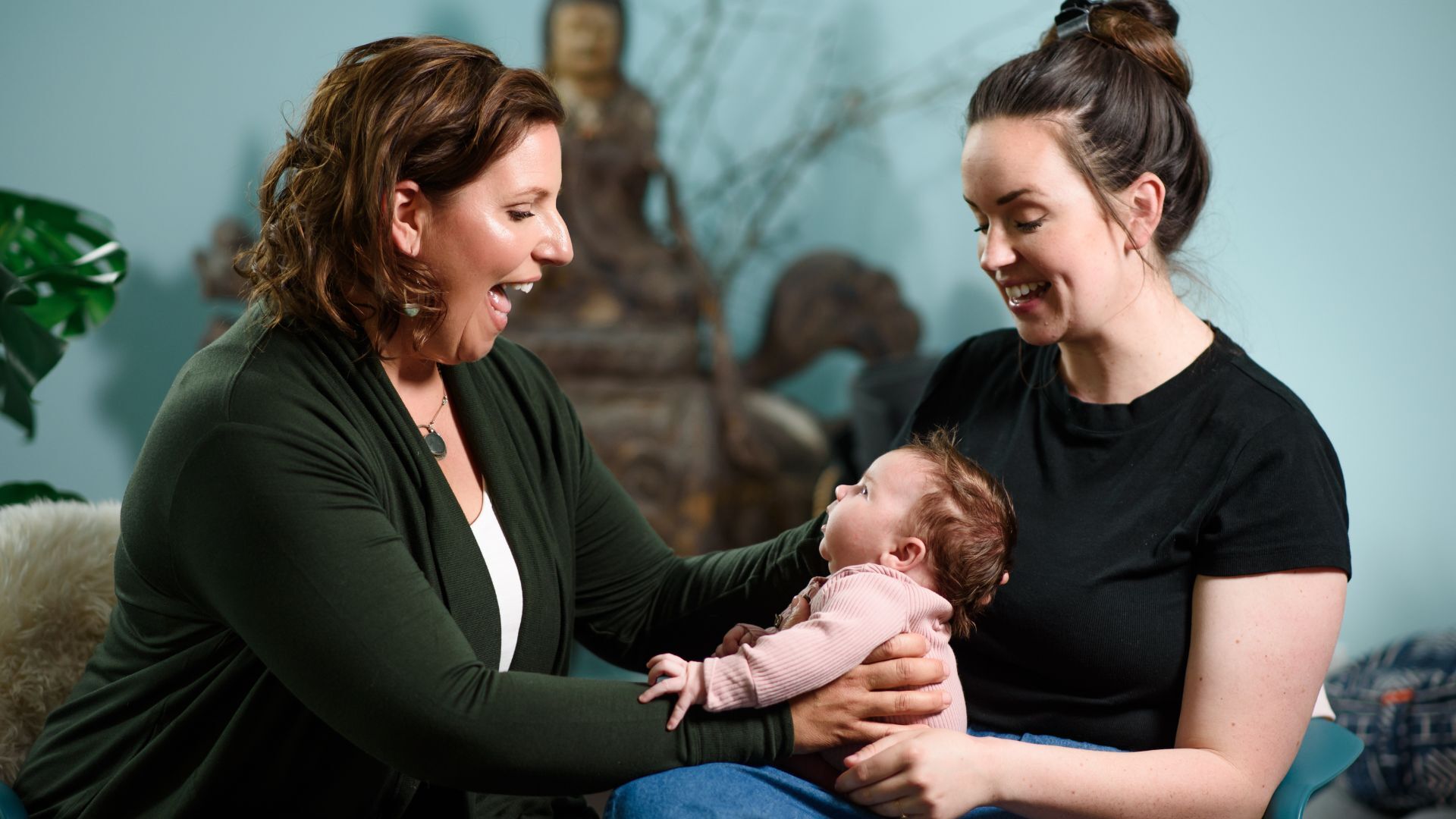 Newborn baby and two women