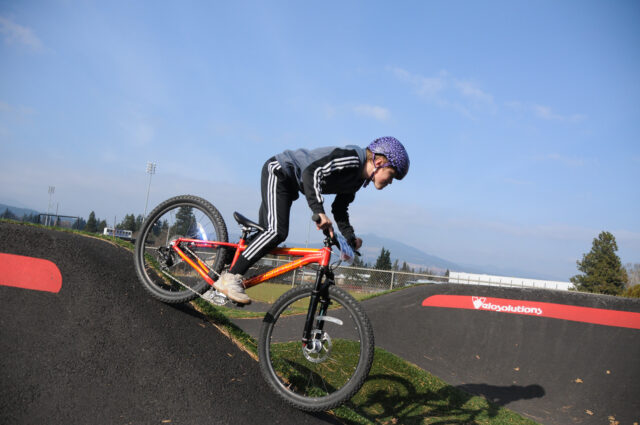 Kid biking on the Pump track at Golden Eagle Park in Hood River, Oregon