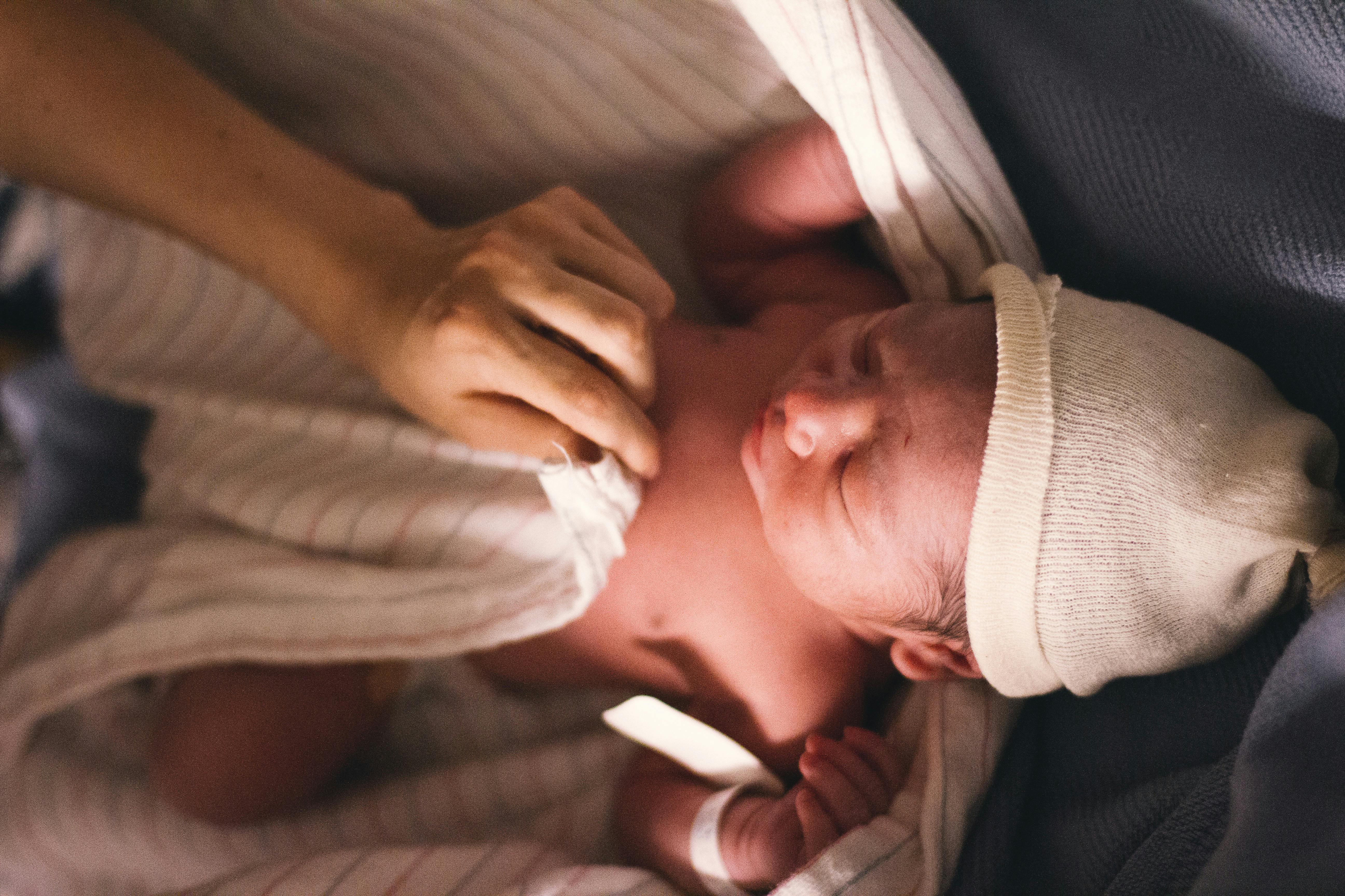 Newborn baby being wrapped up